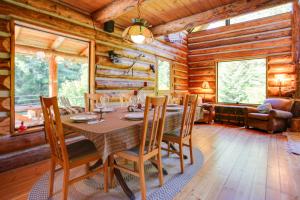 a dining room with a table and chairs in a log cabin at Cozy Easton Cabin with Wenatchee Natl Forest Views! in Cabin Creek