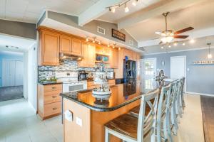 a large kitchen with wooden cabinets and a large island at Secluded Avinger Home with Lake Access! in Avinger