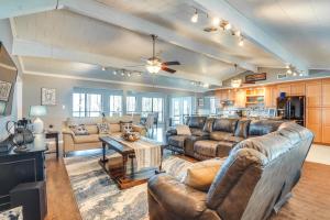 a living room with leather furniture and a kitchen at Secluded Avinger Home with Lake Access! in Avinger