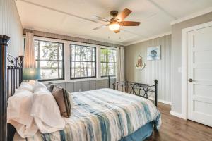 a bedroom with a bed and a ceiling fan at Secluded Avinger Home with Lake Access! in Avinger