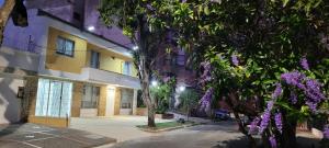 a building with purple flowers in front of it at Casa 59 - Guest House in Bucaramanga