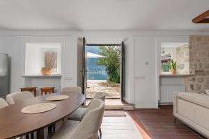 a dining room with a table and chairs at Casa Spada by Belsize in Kotor