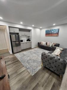 a living room with a couch and a kitchen at Cozy one bedroom in Airdrie in Airdrie