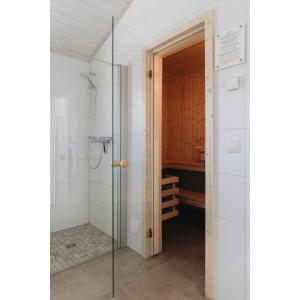 a bathroom with a shower and a glass door at SeeHus - Nordhorn in Nordhorn