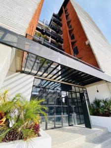 a building with a glass door and a tall building at Luxurious and Modern Apartment in North Zone in Aguascalientes