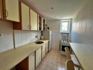 a small kitchen with a sink and a stove at Apartmán v centre in Banská Bystrica