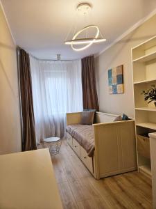 a small bedroom with a bed and a window at Nadmorski Familok in Rozewie