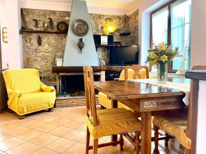 a dining room with a table and a fireplace at Il Trebbio in Barga