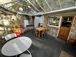 a living room with a table and chairs at 2 Apse Castle Cottages Charming 16th-Century Cottage in Shanklin - Dog-Friendly, Parking, Near Beach Sleeps 5 in Shanklin