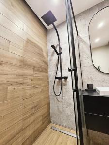a bathroom with a shower with a shower head at Nadmorski Familok in Rozewie