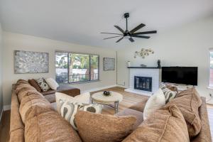 a living room with a large couch and a fireplace at Las Vegas Home with Pool about 4 Mi to Las Vegas Strip! in Las Vegas