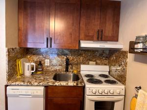 a kitchen with a sink and a stove and cabinets at Yosemite Condominium Loft unit -B202 in Yosemite West