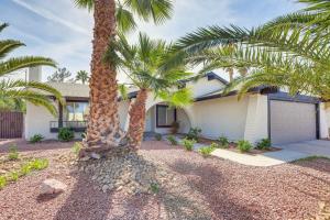 a house with two palm trees in front of it at Las Vegas Home with Pool about 4 Mi to Las Vegas Strip! in Las Vegas
