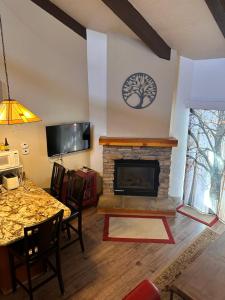 a living room with a fireplace and a dining table at Yosemite Condominium Loft unit -B202 in Yosemite West