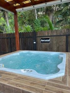 a jacuzzi tub in a backyard with a wooden fence at Villa Palma -Private villa in the mountains in La Cuaba