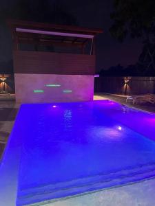a swimming pool at night with purple lights at Villa Palma -Private villa in the mountains in La Cuaba