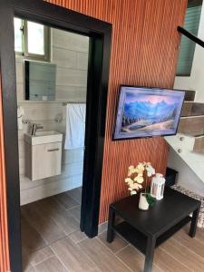 a bathroom with a sink and a toilet and a table at Villa Palma -Private villa in the mountains in La Cuaba