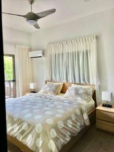 a bedroom with a large bed with a ceiling fan at Villa Palma -Private villa in the mountains in La Cuaba