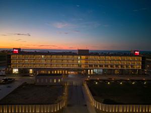 a large building with lights in front of it at Flow Hotel Benguela in Benguela