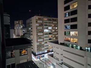 a city skyline at night with tall buildings at Loft Central in Passo Fundo