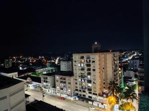 a view of a city at night with buildings at Loft Central in Passo Fundo