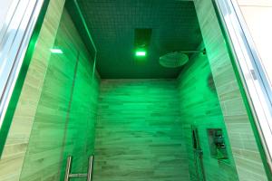 a shower in a building with green lighting at La Villa - Rainbow House in Martina Franca