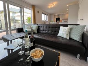 a living room with a couch and a table with a bowl of food at 4 The Bayhouse in Shanklin
