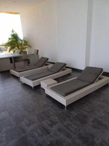 a row of empty beds in a room at The Edge in Accra