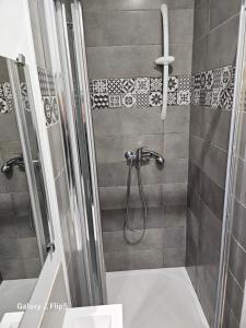 a bathroom with a shower with a shower head at Chambre DUO in Beauvais
