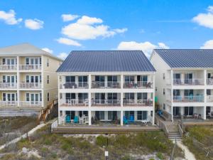 a row of houses on the beach at Eastern Shores on 30A by Panhandle Getaways in Seagrove Beach