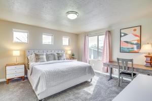 Un pat sau paturi într-o cameră la South Salt Lake Home with Hot Tub 7 Mi to Downtown