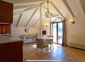 a kitchen and living room with a table and chairs at Villa Renata & Magic Suite in Parga