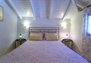a bedroom with a large pink bed with two lamps at Villa Renata & Magic Suite in Parga