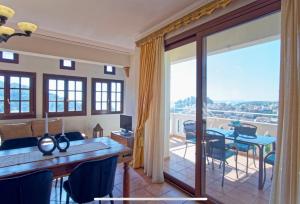 a living room with a table and a balcony at Villa Renata & Magic Suite in Parga