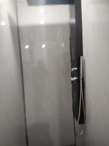 a glass door of a bathroom with a phone at sunset lodge 