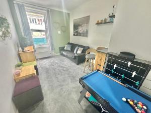 a living room with a pool table and a couch at Homely Apartment in the Heart of Town Centre - Sleeps 6 in Bournemouth