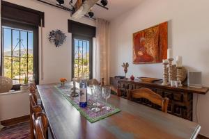 a dining room with a table with wine glasses on it at villa larwik frigiliana in Frigiliana