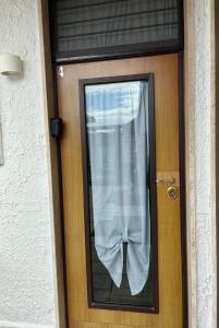 a door with a window with a curtain on it at Truly Apulia in Bari