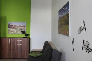 a living room with a couch and a cabinet at Apartments Verona Karlovy Vary in Karlovy Vary