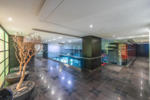 a lobby of a building with glass walls and plants at Modern 2-Bedroom Condo w Floor to Ceiling Windows in Toronto