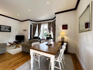 a living room with a table and a couch at 6 Shanklin Manor - family friendly apartment in Shanklin Old Village in Shanklin