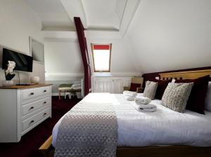 a bedroom with a large white bed and a window at 6 Shanklin Manor - family friendly apartment in Shanklin Old Village in Shanklin