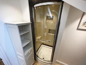 a shower with a glass door in a bathroom at 6 Shanklin Manor - family friendly apartment in Shanklin Old Village in Shanklin +37 photos
