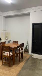 a dining room table with chairs and a black door at HeiJo's Homestay in Jowai +21 photos