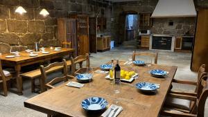a dining room with wooden tables and chairs at Pazo de San Pedro de Bembibre in Taboada
