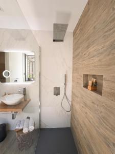 a bathroom with a sink and a toilet and a mirror at Calumidda in Catania