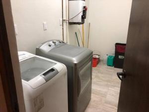 a laundry room with a washing machine and a washer at Dpto Centro Histórico Puebla in Puebla