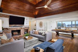 a living room with a fireplace and a pool table at Family Beach house in Carlsbad
