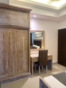 a room with a wooden cabinet and a table and chair at Ocean Breeze Sea Haven Luxury Apartments in Negombo +24 photos