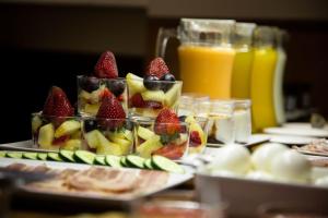 a table topped with plates of fruit and juice at Charminghomesgranada Apartamento Fajalauza in Granada